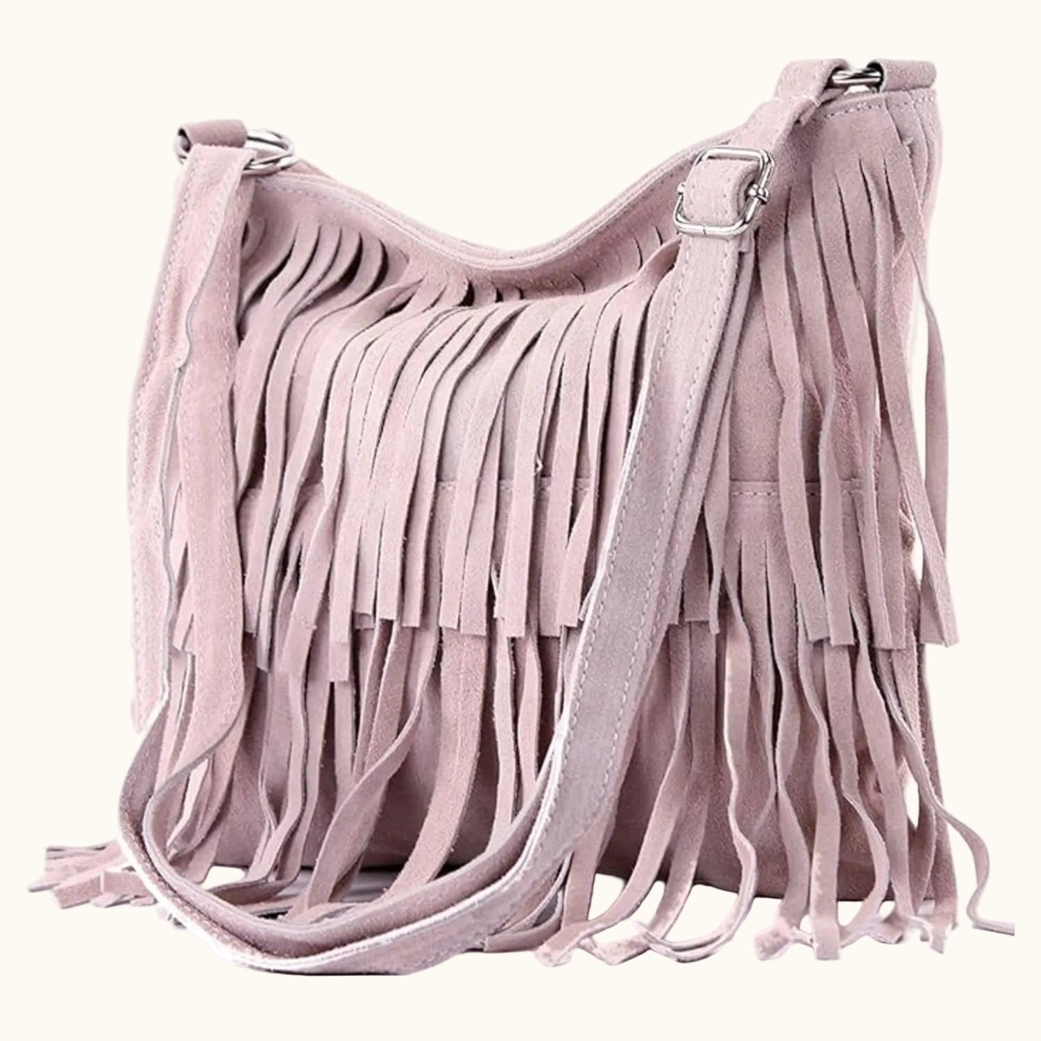 Pink suede handbag with fringe details on a white background