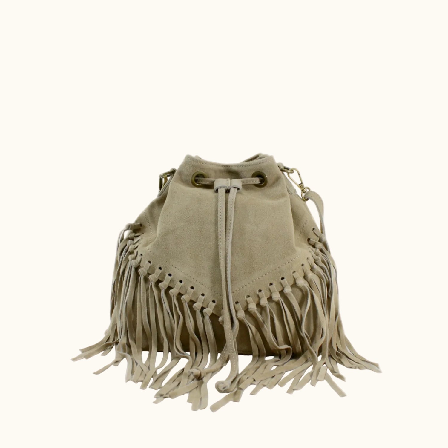 Beige suede bag with fringe details on a white background