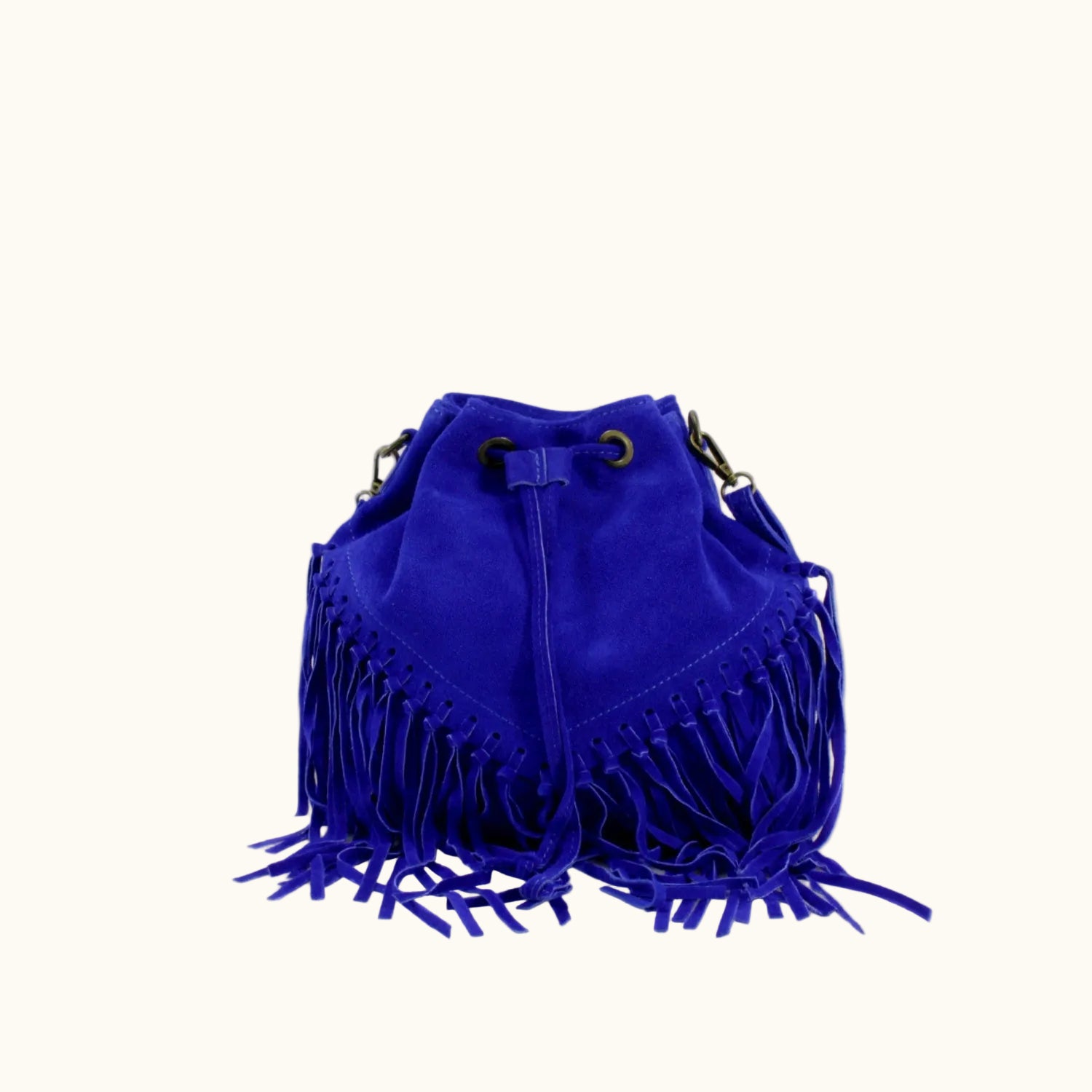 Blue suede handbag with fringe details on a white background