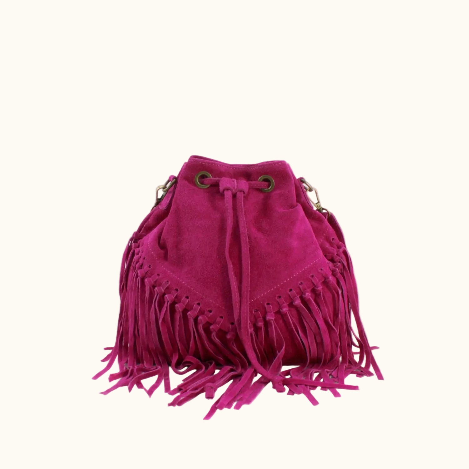 Pink suede handbag with fringe details on a white background