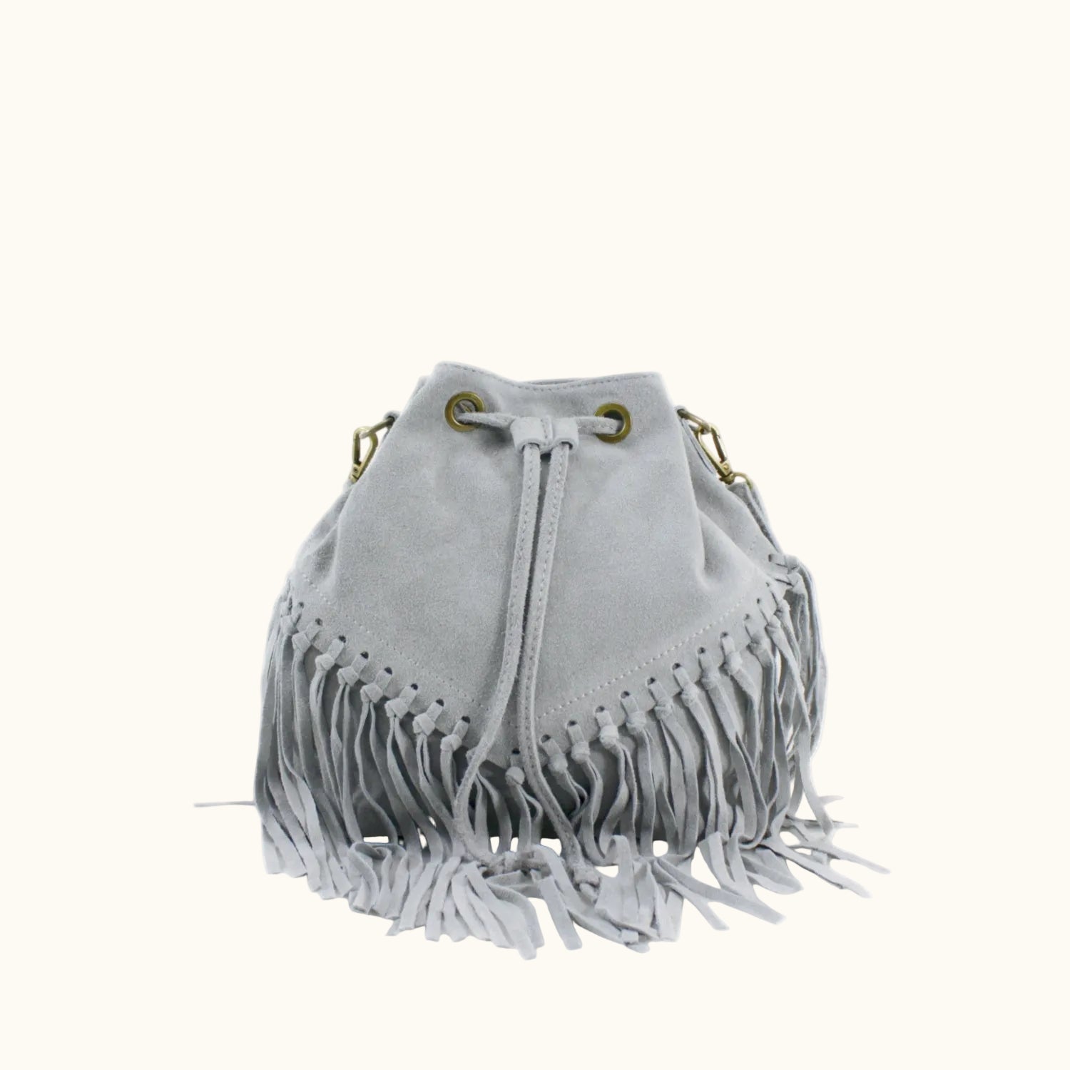 Gray suede handbag with fringe details on a white background
