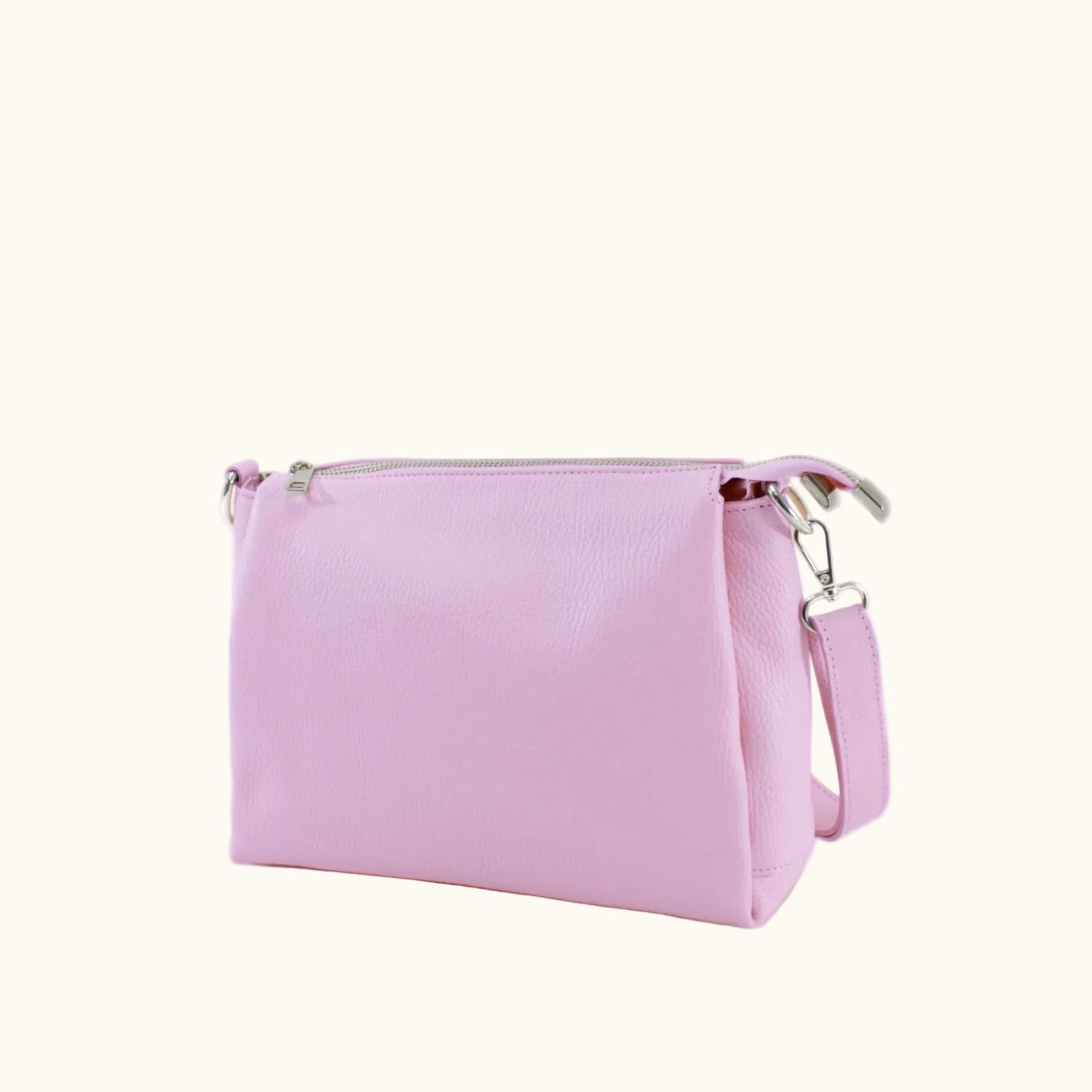 Pink handbag with a strap on a white background