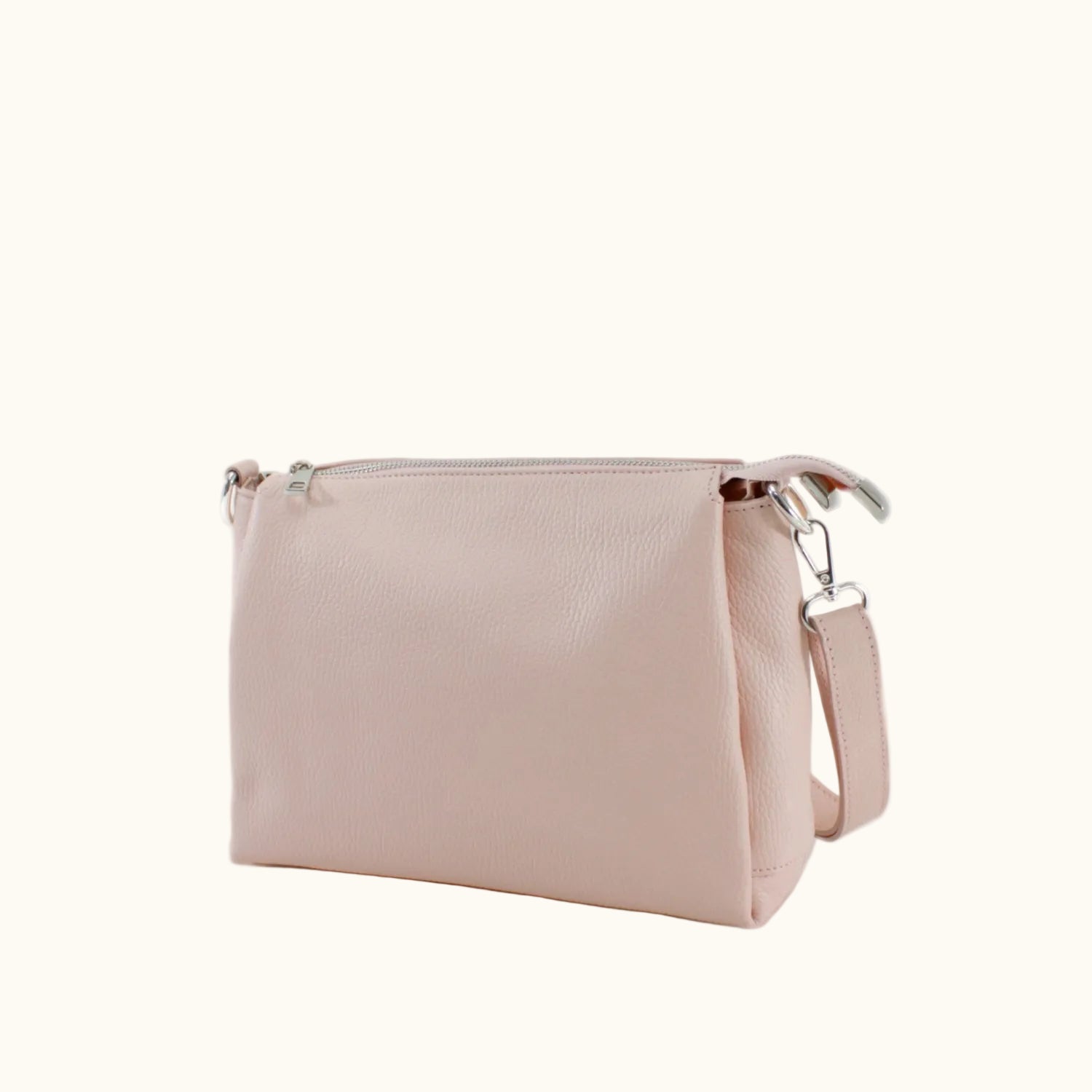 Pink handbag with a strap on a white background