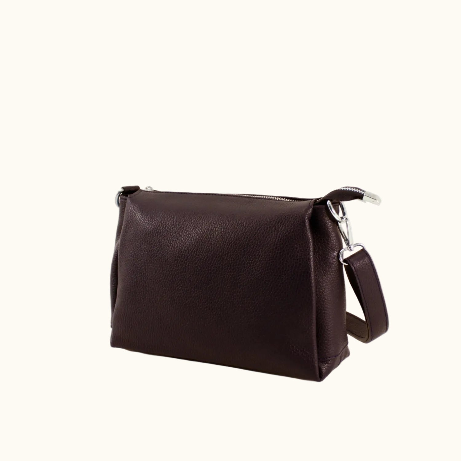 Brown leather bag with a strap on a white background