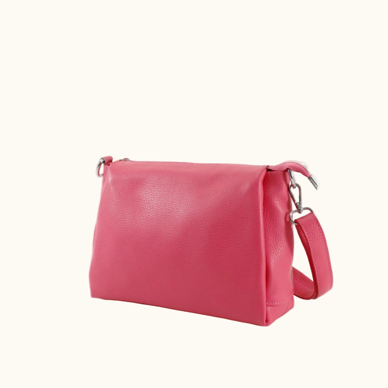 Pink handbag with a strap on a white background