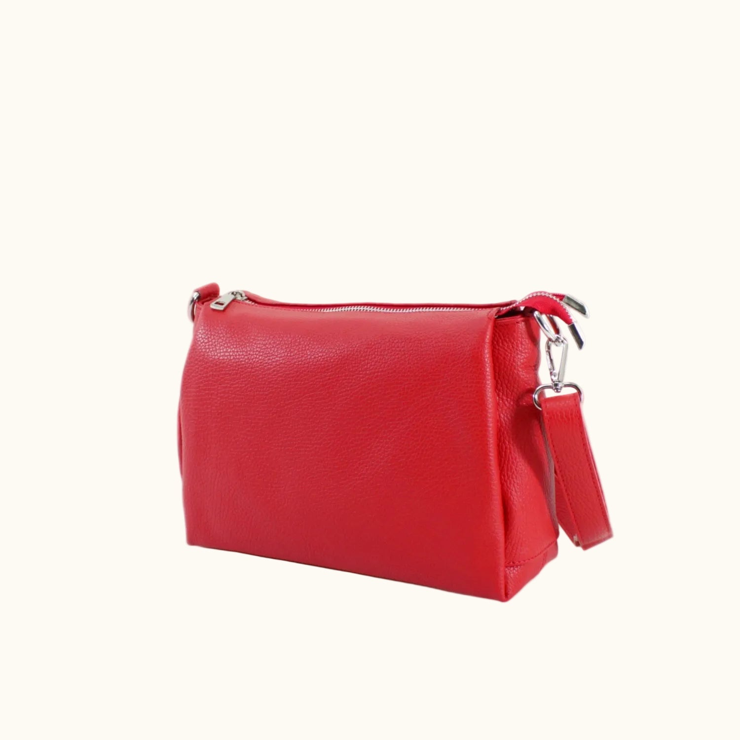 Red handbag with a strap on a white background