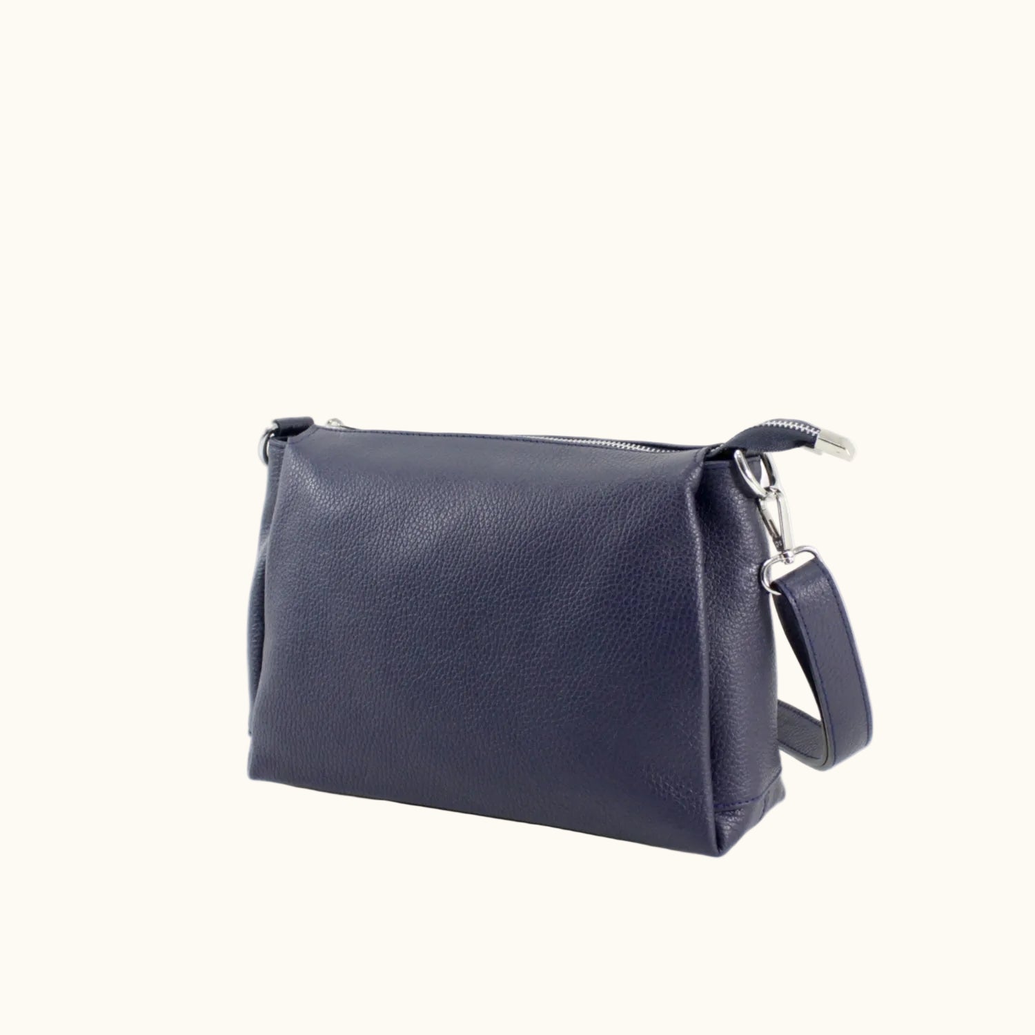 Navy blue leather bag with a strap on a white background