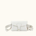 White handbag with gold accents on a white background