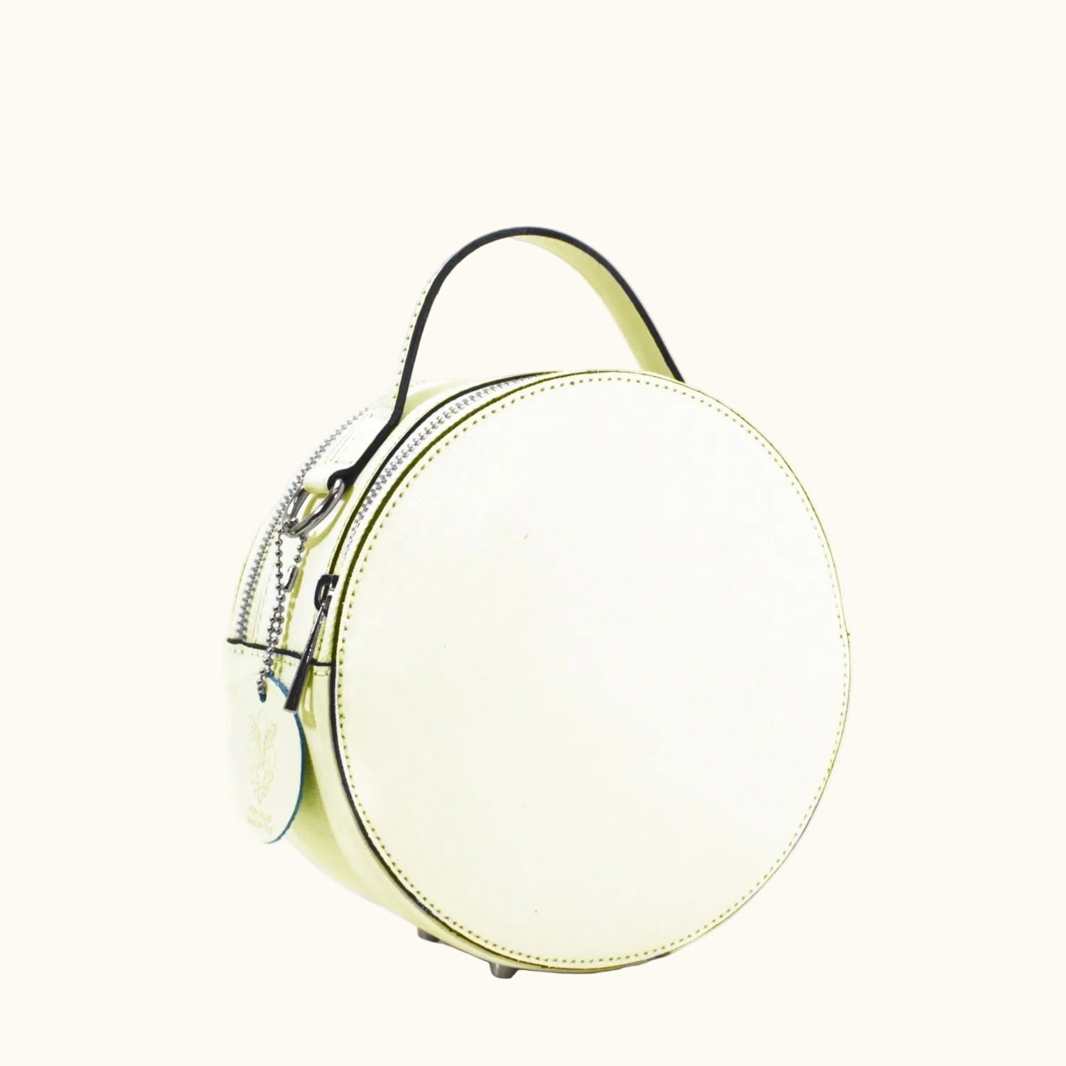 Round white handbag with black handle on a white background