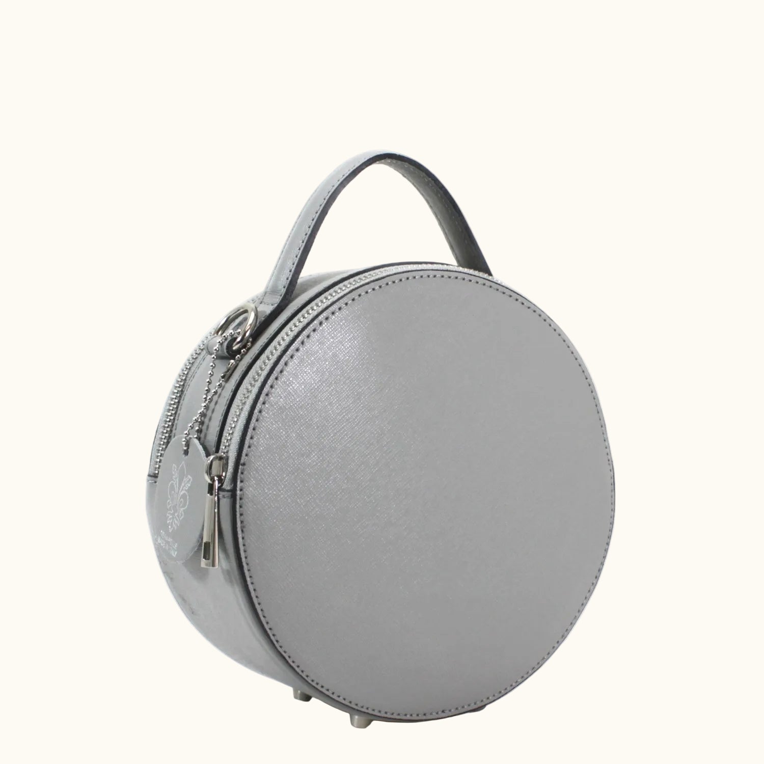 Round gray handbag with a handle on a white background