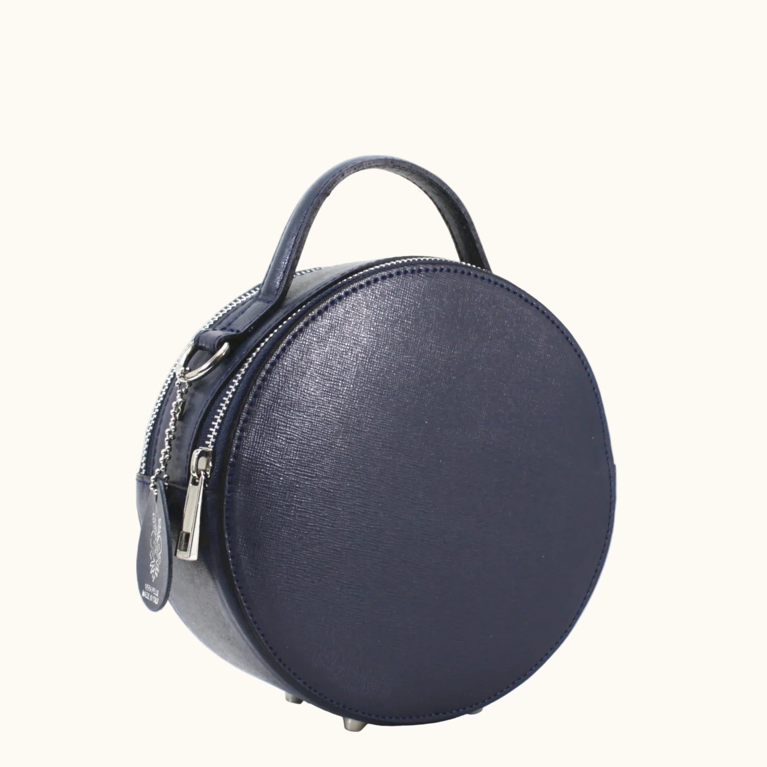 Navy blue round handbag with a handle on a white background