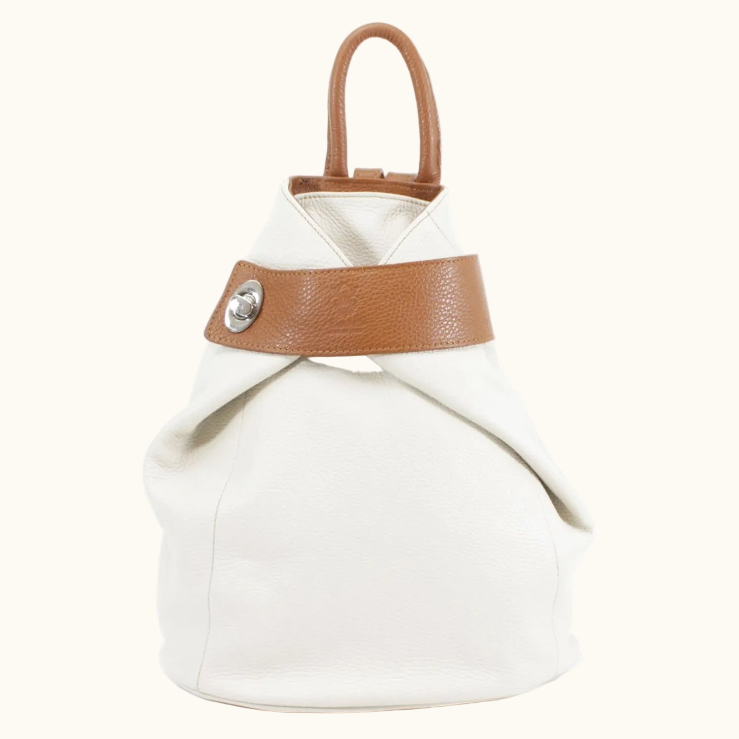 White bag with brown leather strap and handle on a white background