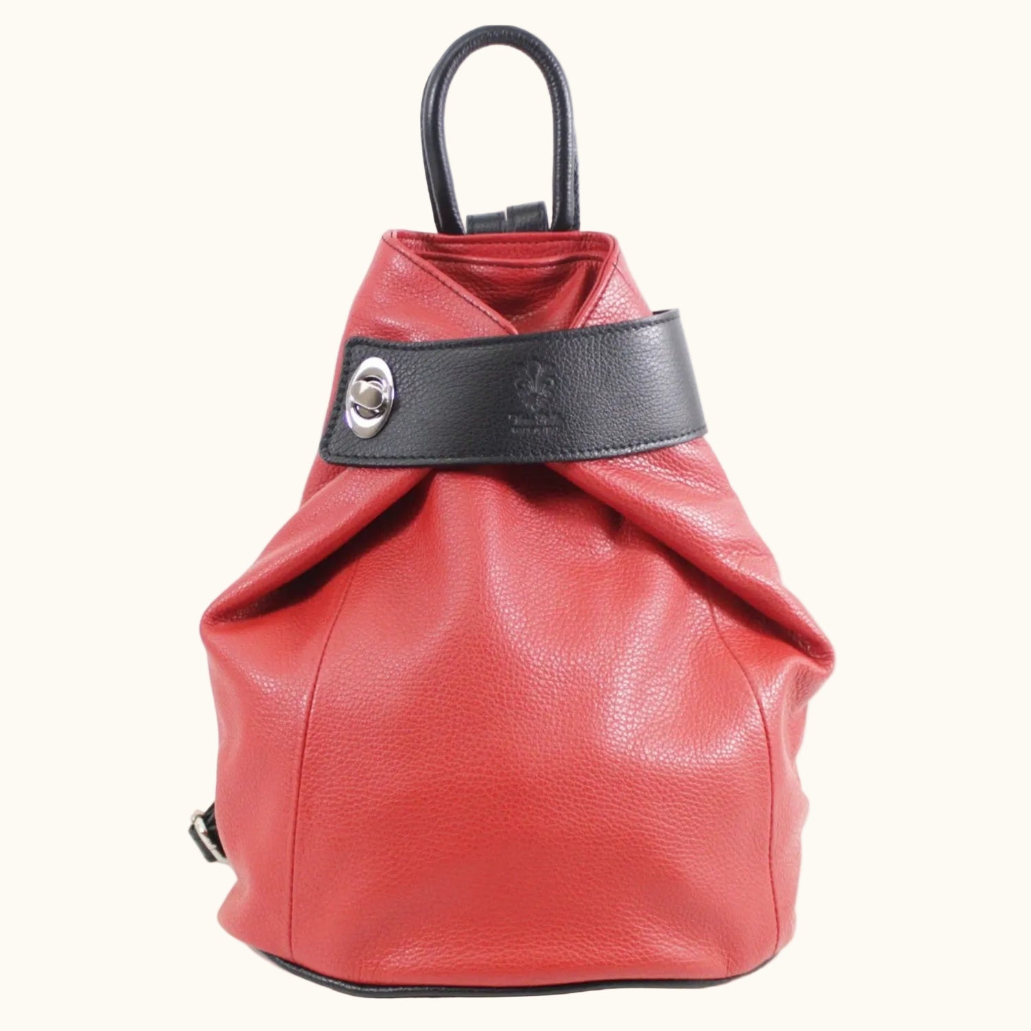 Red leather backpack with black band and handle on a white background