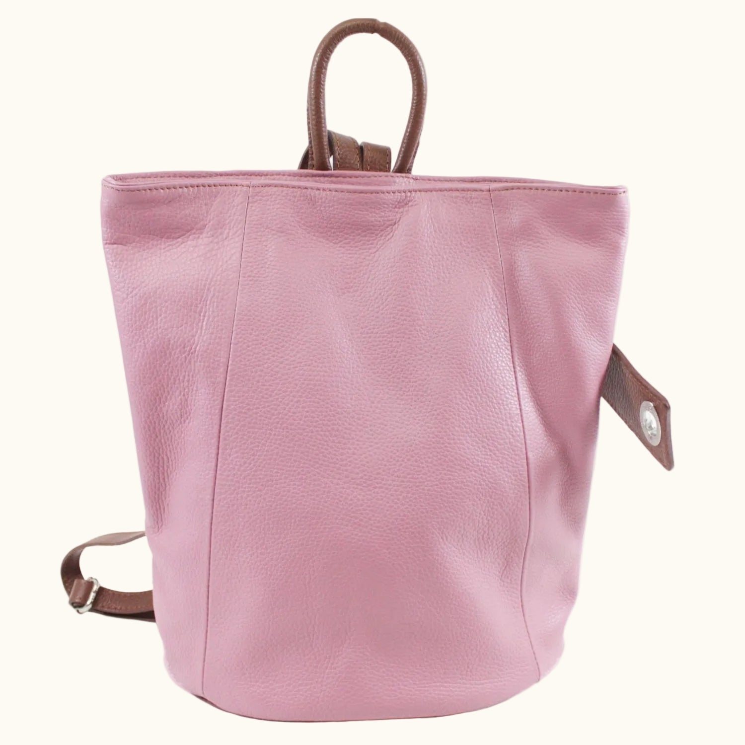 Pink backpack with brown straps on a white background