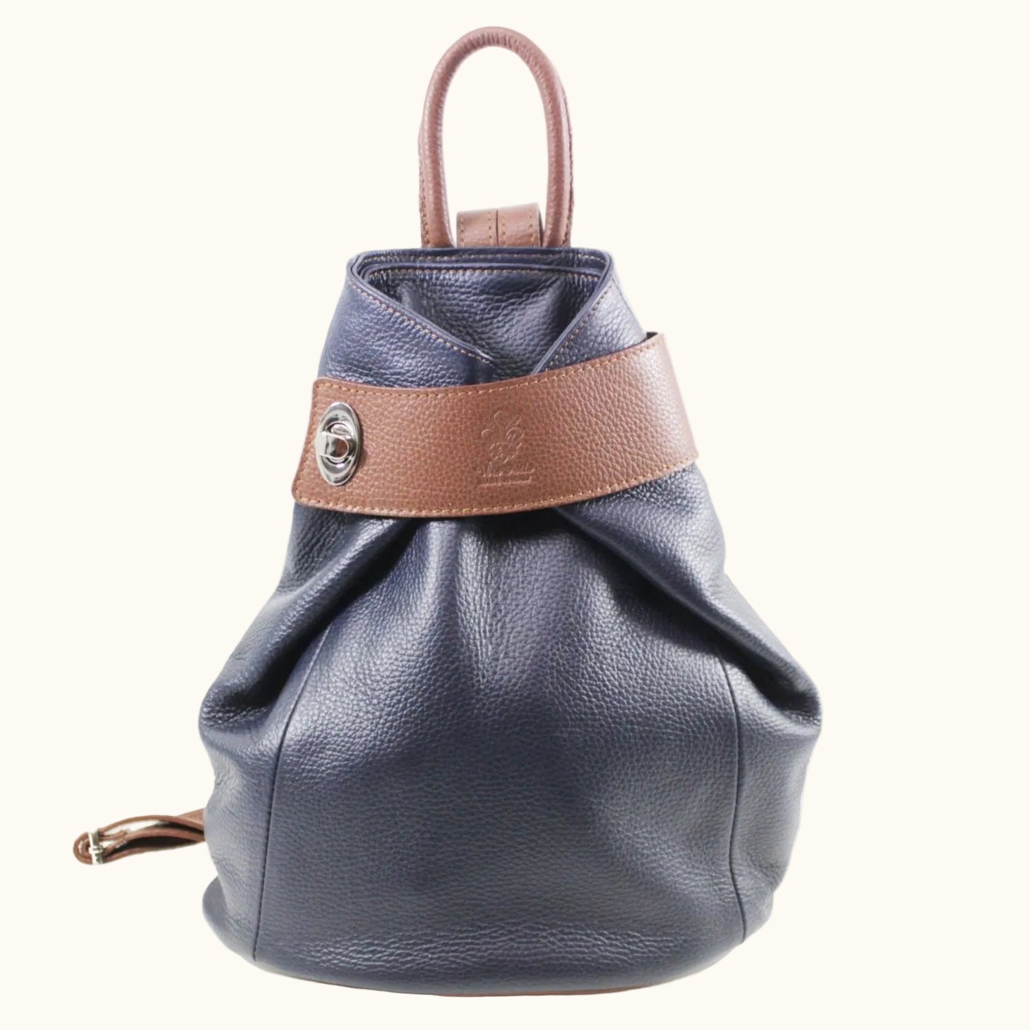 Blue leather backpack with brown strap on a white background