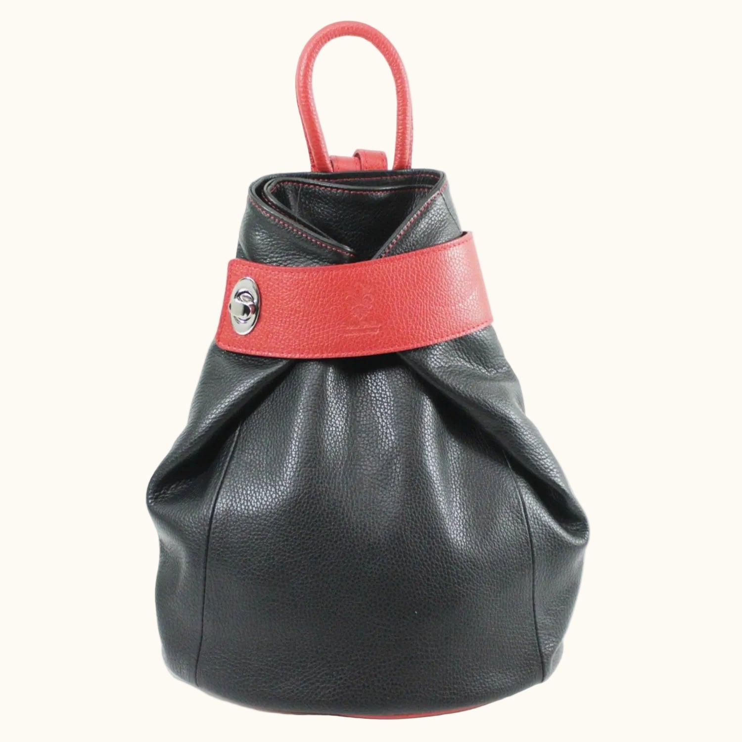 Black leather bag with a red strap on a white background