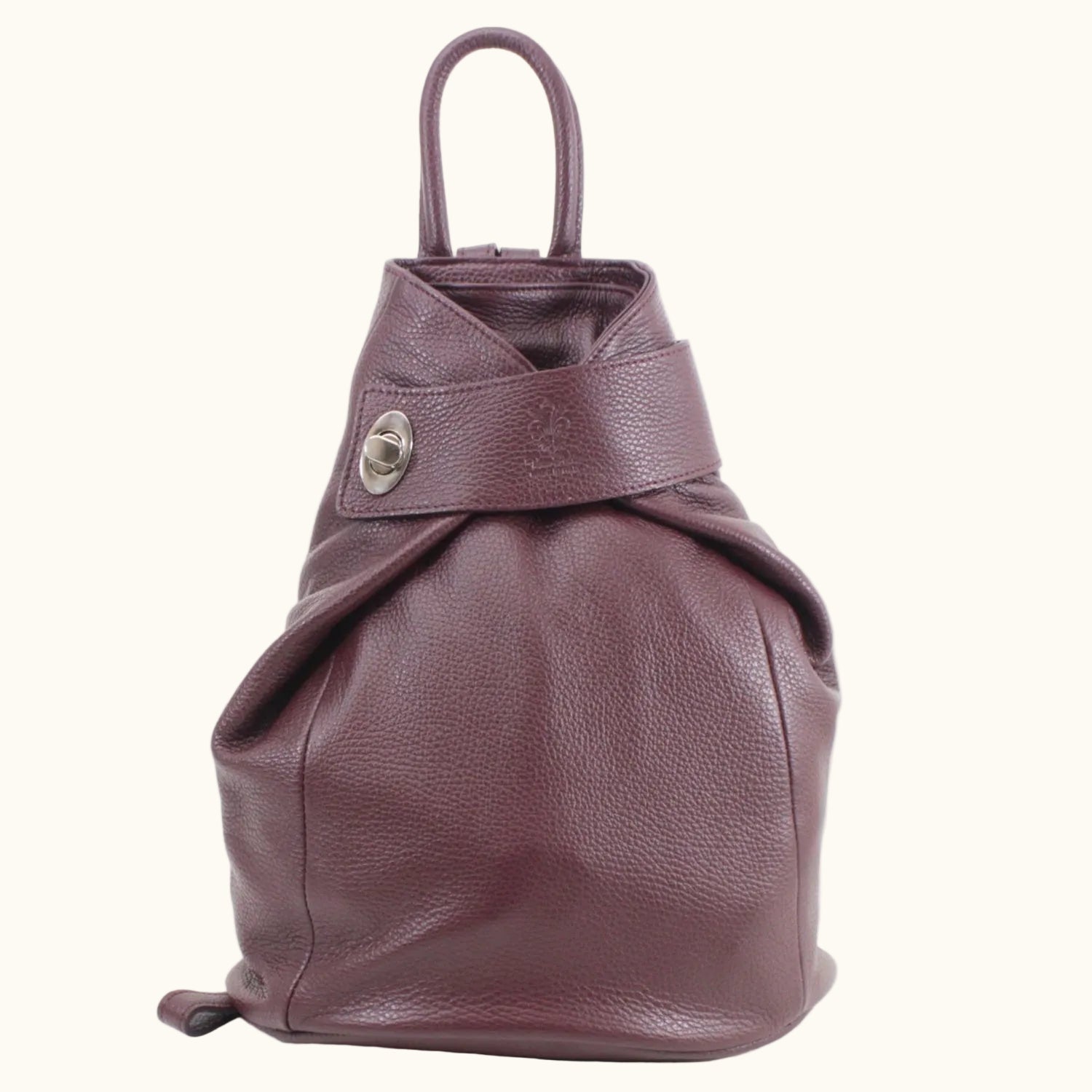 Purple leather bag with a strap on a white background