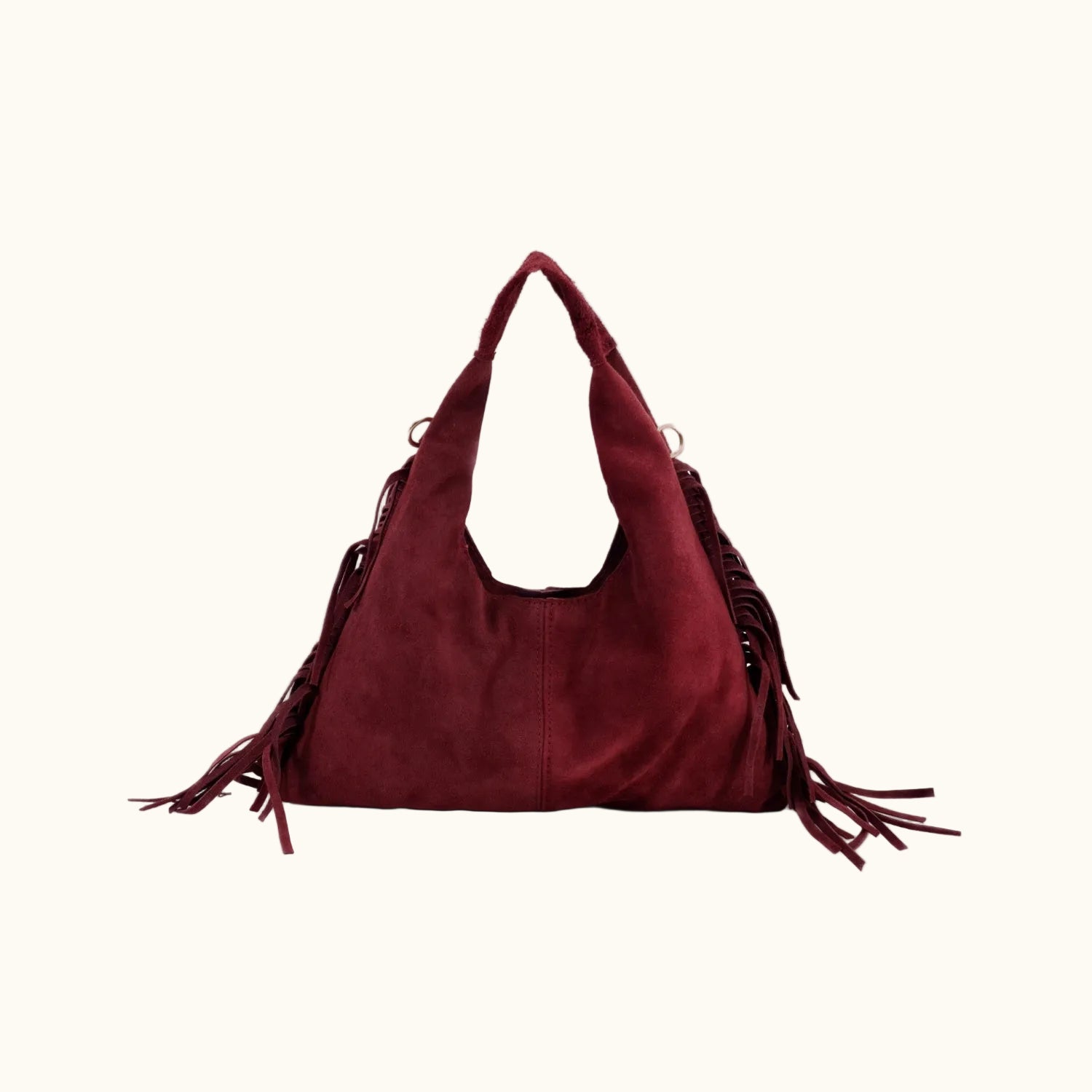 Maroon handbag with fringe details on a white background
