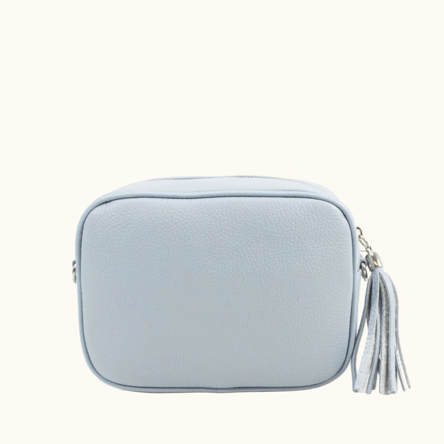 Light blue crossbody bag with a tassel on a white background