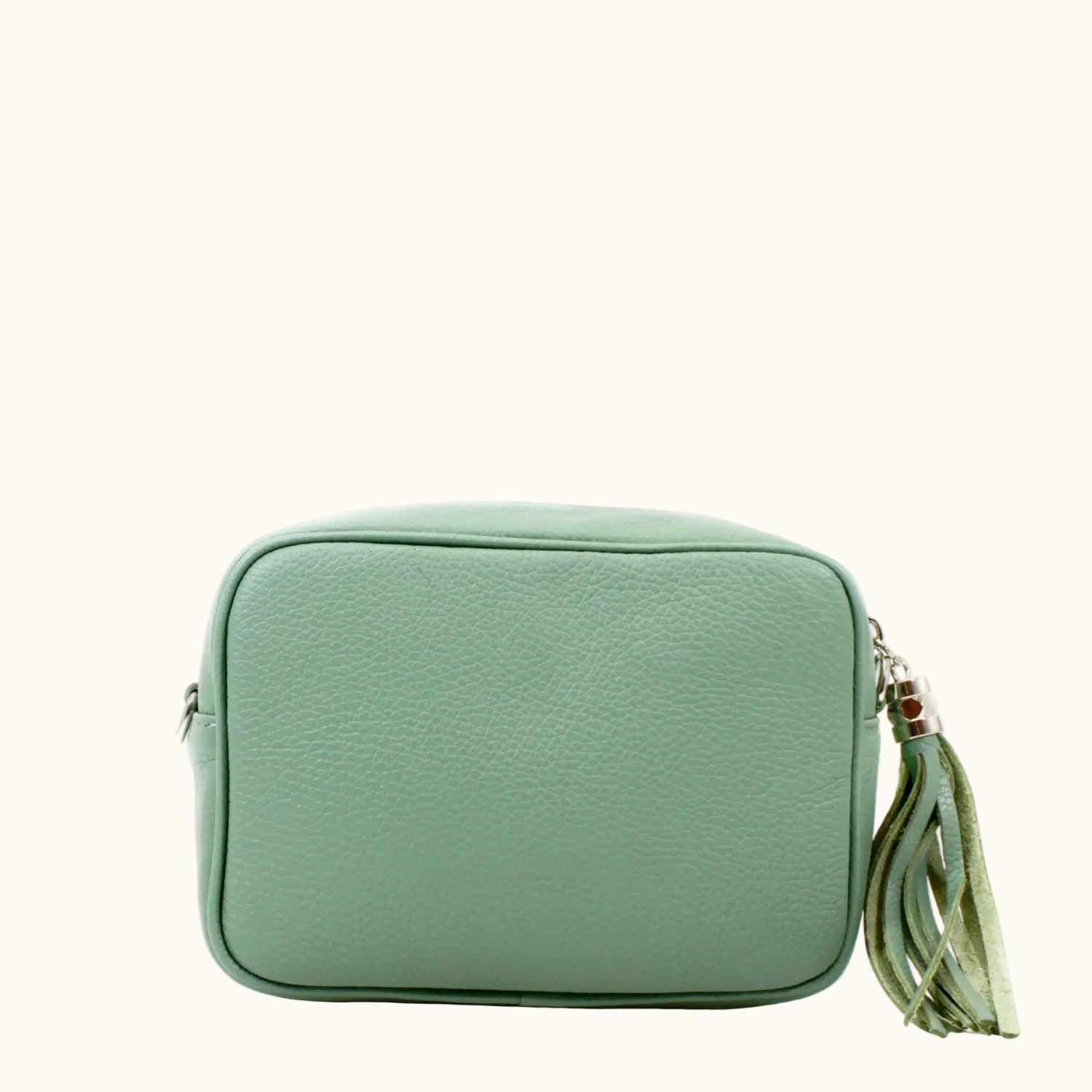 Green handbag with a tassel on a white background