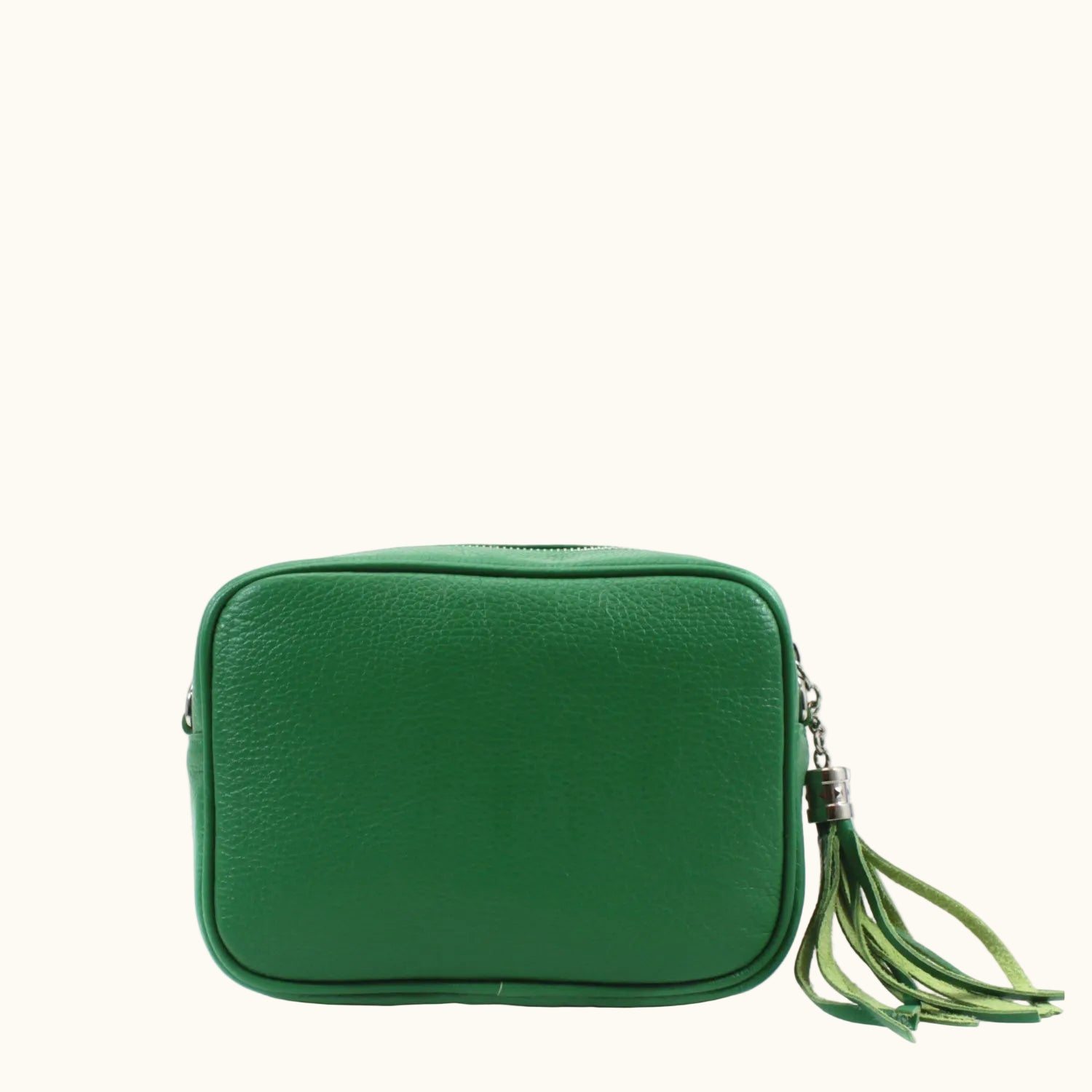 Green leather crossbody bag with a tassel on a white background