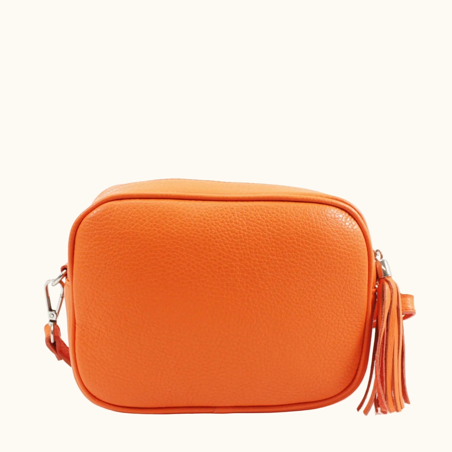 Orange crossbody bag with tassels on a white background