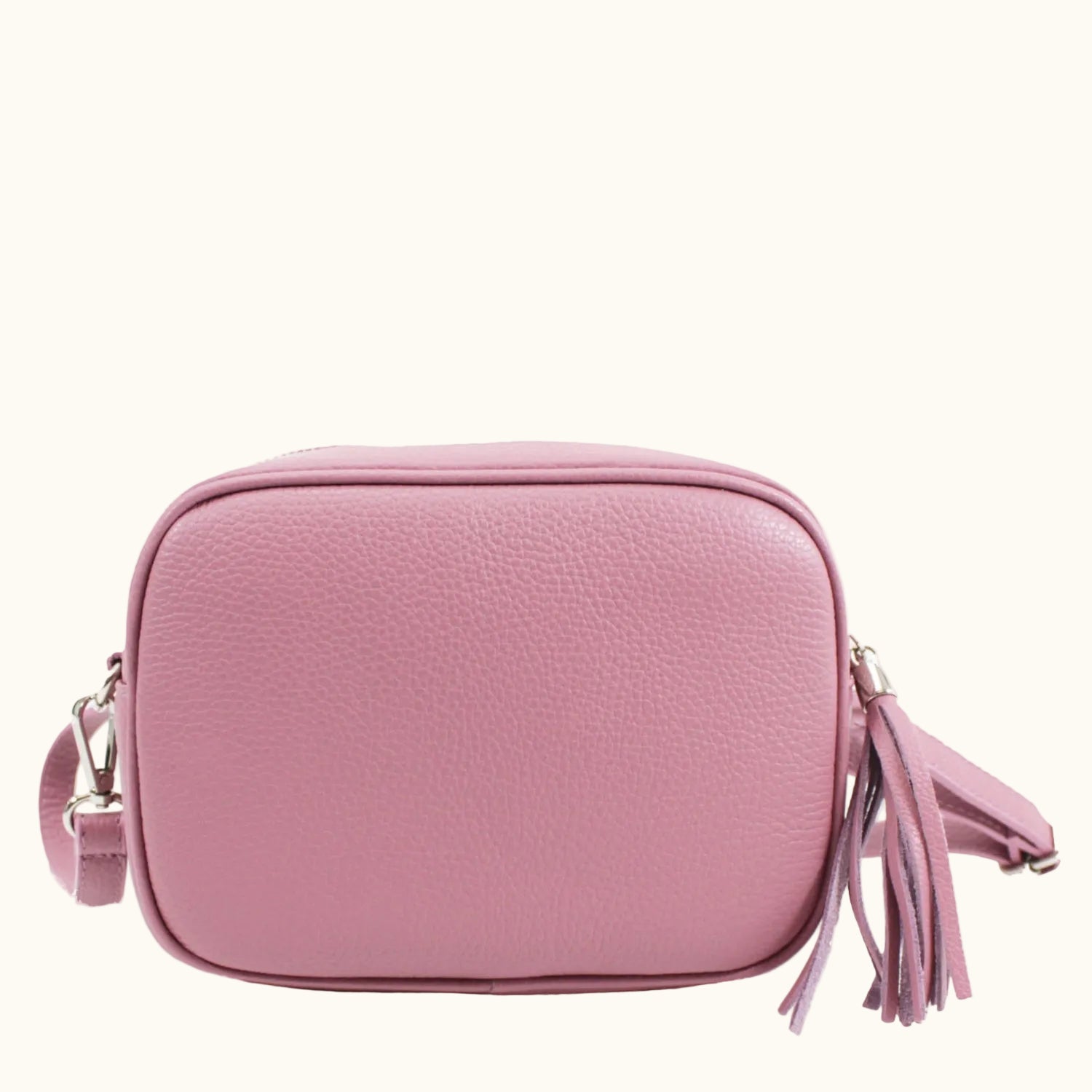 Pink crossbody bag with tassels on a white background