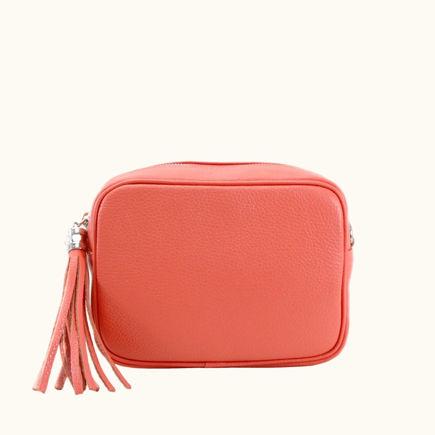 Coral-colored pouch with a tassel on a white background