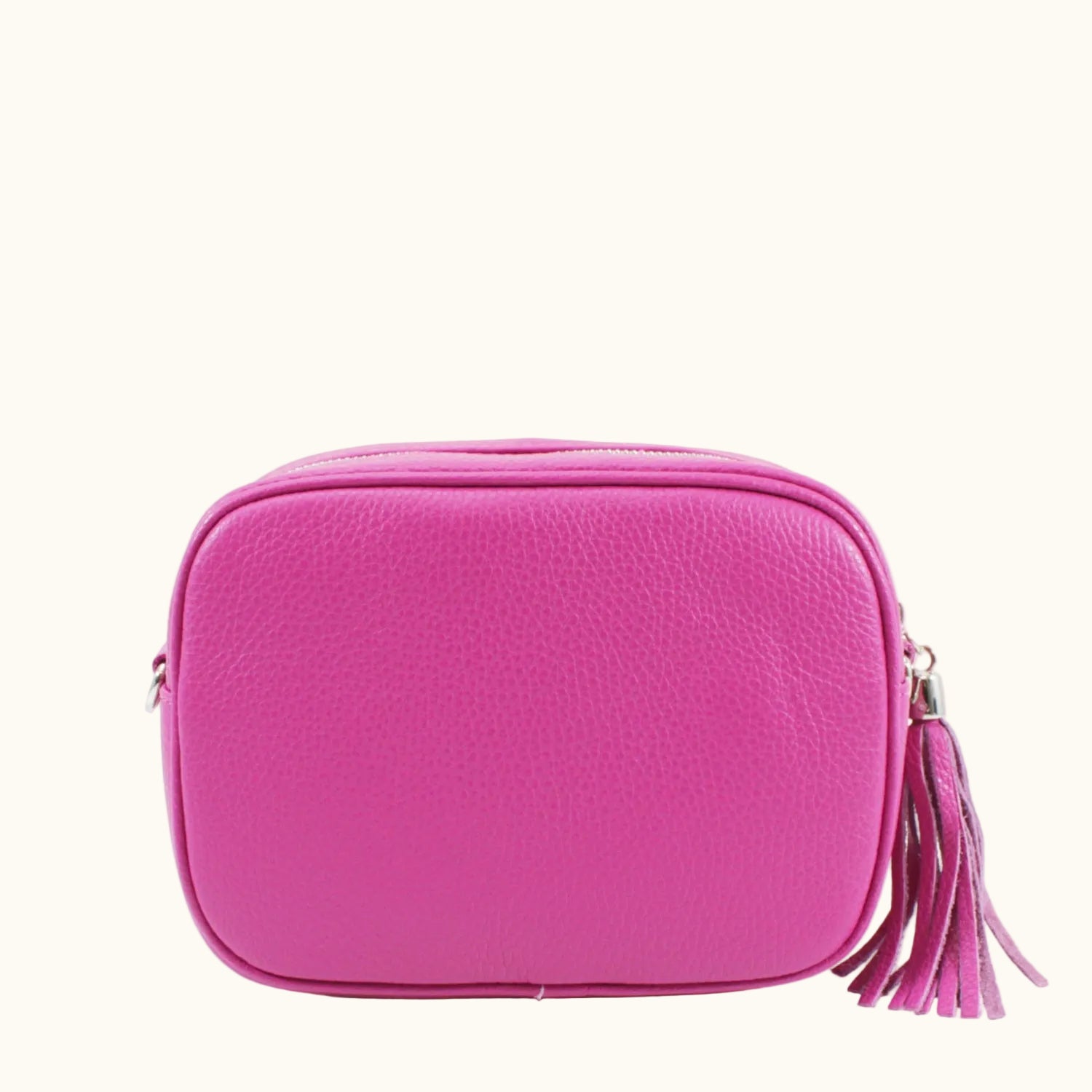 Pink crossbody bag with a tassel on a white background