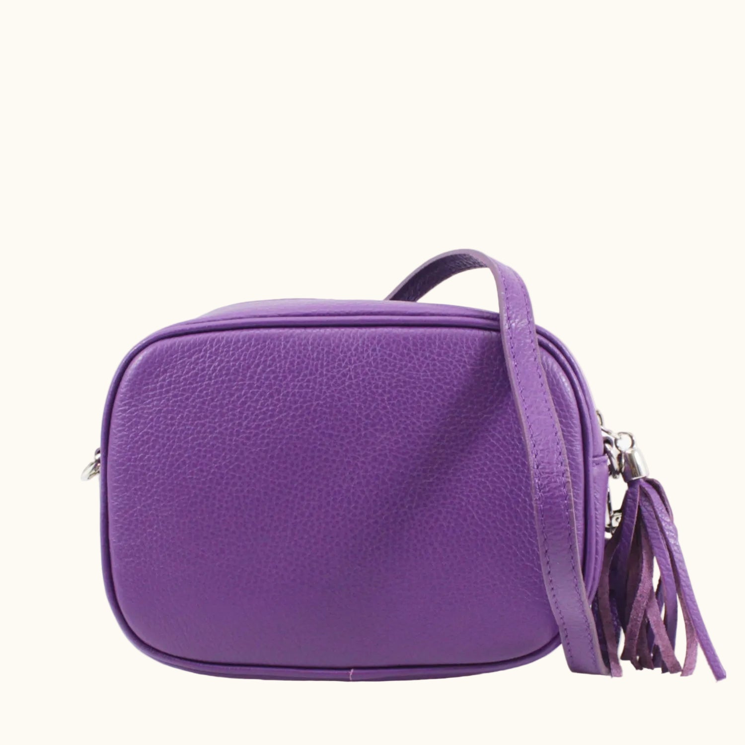 Purple handbag with a tassel on a white background