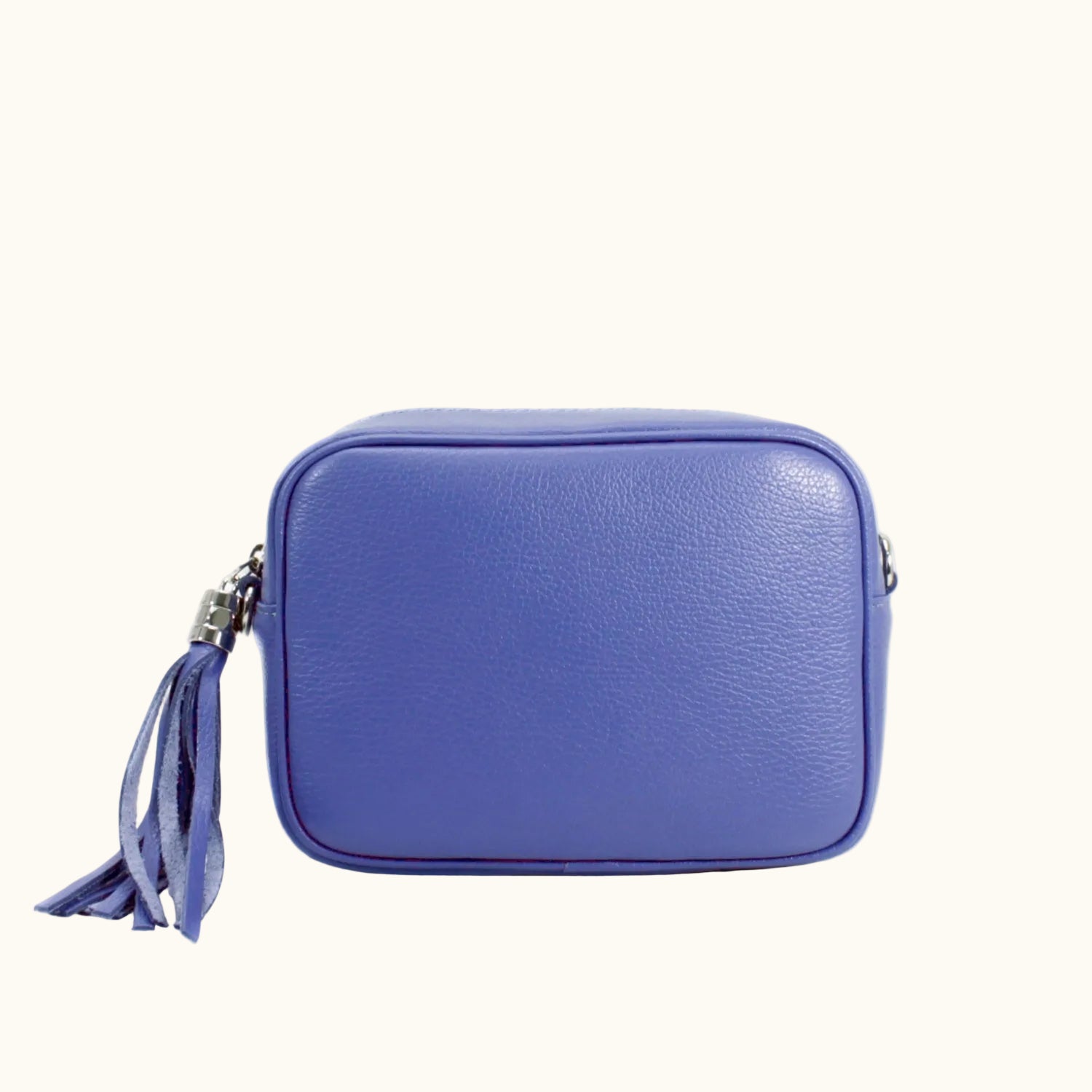 Blue leather crossbody bag with a tassel on a white background