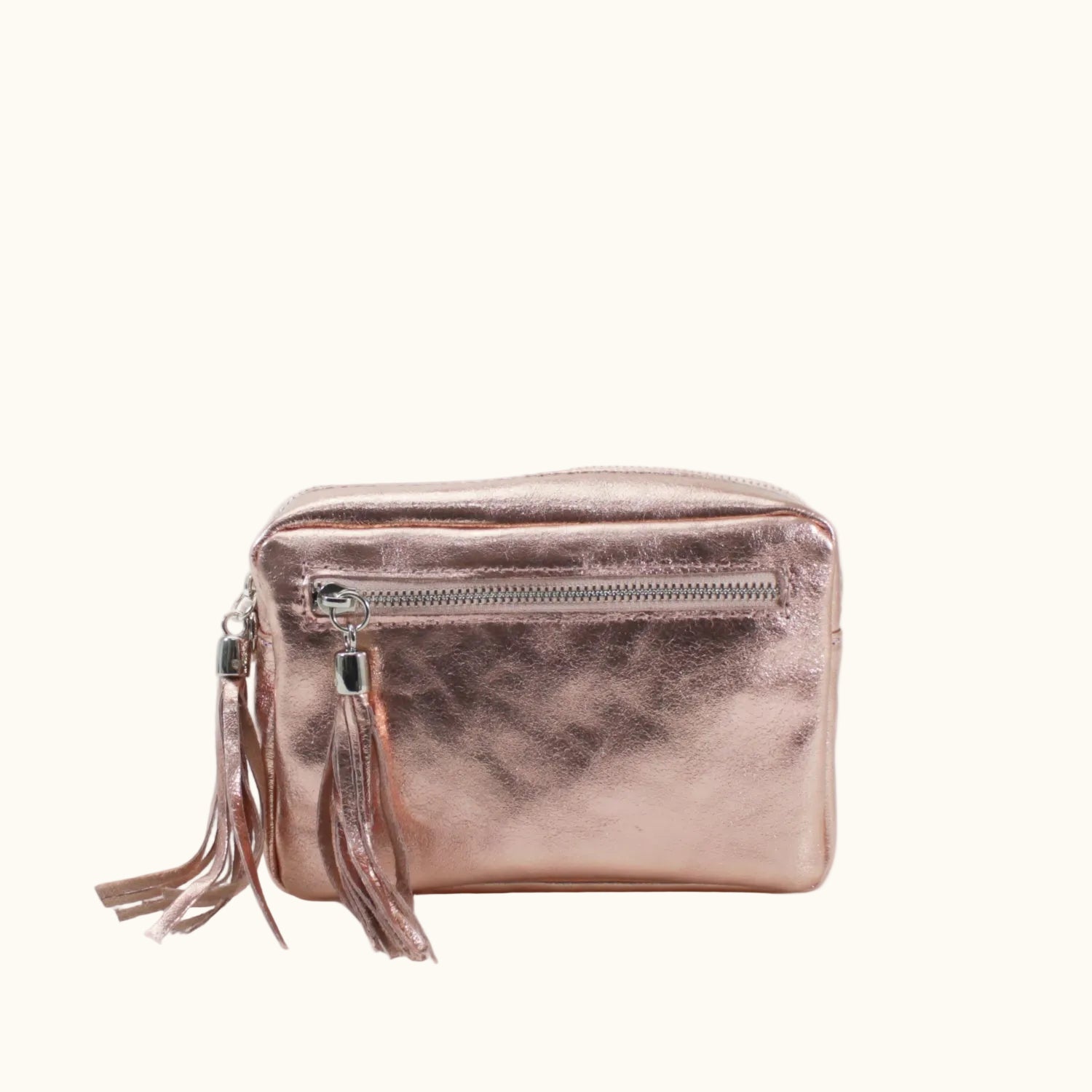 Rose gold clutch bag with a tassel on a white background