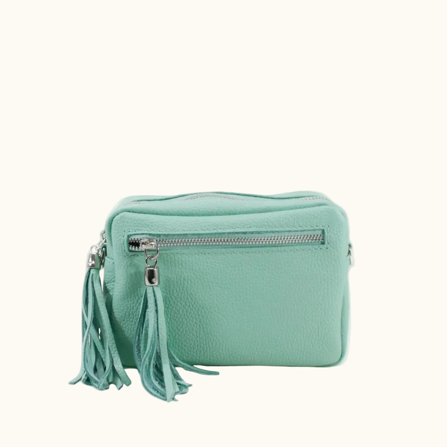 Mint green handbag with tassels on a white background